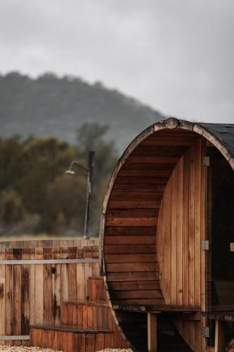 a wooden building with a large wooden door at The Wellness Farm Broke in Broke