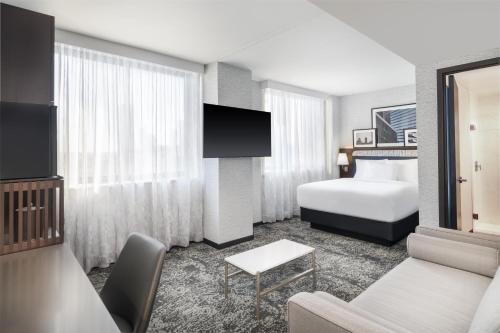 a hotel room with a bed and a couch at DoubleTree by Hilton Long Island City, NY in Long Island City