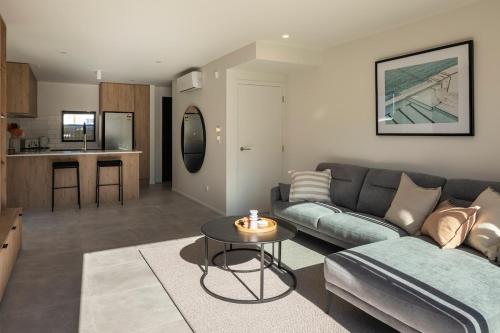 a living room with a couch and a table at New Three Bedroom Townhouse - Walk to the CBD! in Christchurch