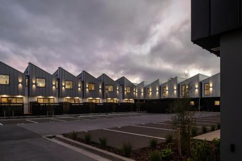 a parking lot in front of a building at New Three Bedroom Townhouse - Walk to the CBD! in Christchurch