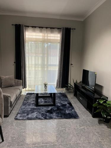 a living room with a couch and a coffee table at Licious Homes 1 in Nalakonge