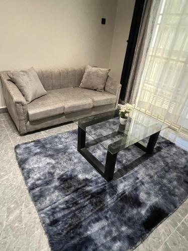 a living room with a couch and a coffee table at Licious Homes 1 in Nalakonge