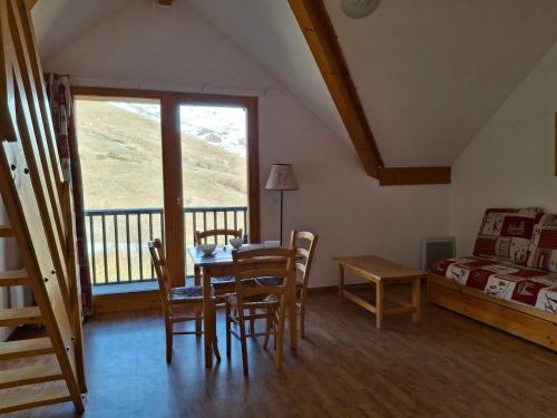 un salon avec une table et des chaises et un lit dans l'établissement T2 confort 4 pers, balcon ensoleillé, proche pistes - FR-1-807-134, à Saint-François-Longchamp