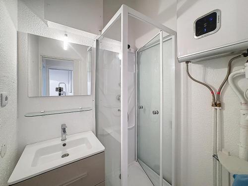 a white bathroom with a sink and a shower at Saintes-Maries-de-la-Mer, 4 pers, résidence aux Launes - FR-1-475-225 in Saintes-Maries-de-la-Mer