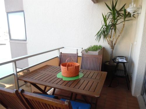 un panier sur une assiette sur une table sur un balcon dans l'établissement Charmant 2 Pièces Proche Plage avec Parking Privé - FR-1-750-102, à Canet