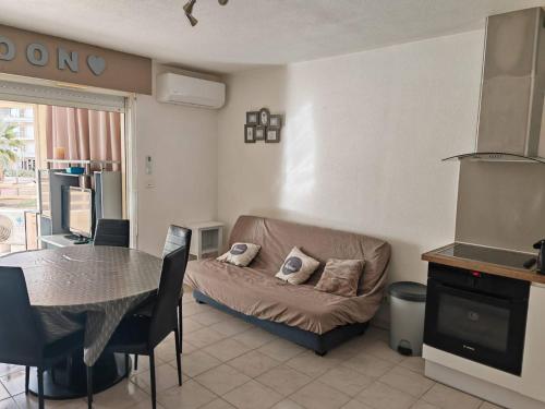 un salon avec un canapé et une table dans l'établissement Appartement 3 pièces face plage - 6 pers, clim, parking - FR-1-750-106, à Canet