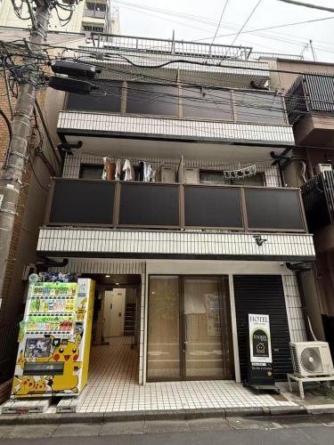 a store front of a building on a street at Tookin house 池袋 in Tokyo