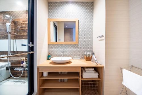 a bathroom with a sink and a mirror at Hotel Naranohamori in Nara
