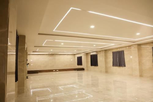 a large room with a dance floor and a ceiling at Rama grand in Tirupati