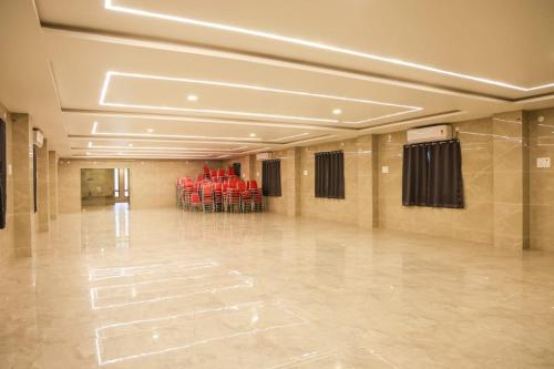 a large empty room with red chairs in it at Rama grand in Tirupati