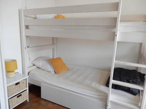 une chambre avec deux lits superposés et un bureau dans l'établissement Studio Cabine 2* avec Parking, Proche Plage - FR-1-750-111, à Canet