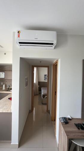 a kitchen with a room with a ceiling fan at PARK VEREDAS - Apto 415 - Vista para Piscina in Rio Quente