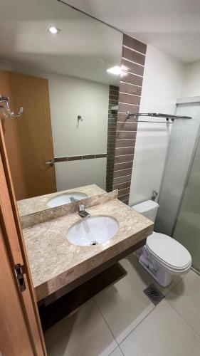 a bathroom with a sink and a toilet at PARK VEREDAS - Apto 415 - Vista para Piscina in Rio Quente