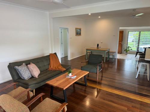 a living room with a couch and a table at Jabiru Stay Daintree Village in Daintree