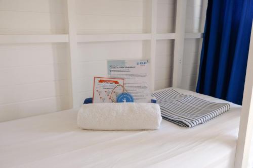 a white bed with a box on top of it at Le Pirate Beach Club Nusa Ceningan - Adults Only in Nusa Lembongan