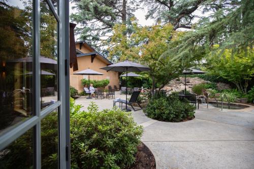 a patio with tables and chairs and umbrellas at Appellation Lodi - Wine & Roses Resort and Spa in Lodi