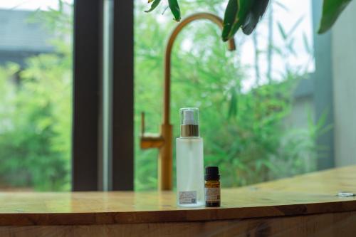 a bottle of essential oil sitting on a wooden counter at Phoenix Dragon M.I.C.E Hotel in Kunming