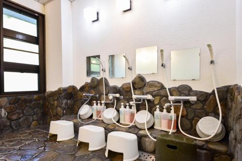 a bathroom with four sinks and four toilets at Bijintei in Tanabe