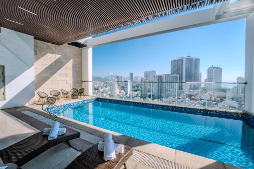 a swimming pool with a view of the city at Astica Hotel Nha trang in Nha Trang