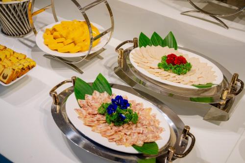 a table with three plates of food on it at Astica Hotel Nha trang in Nha Trang