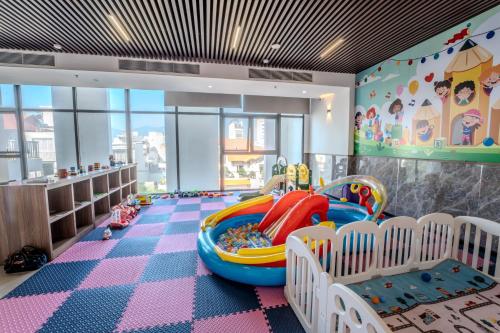 a childs room with a play area with a slide at Astica Hotel Nha trang in Nha Trang
