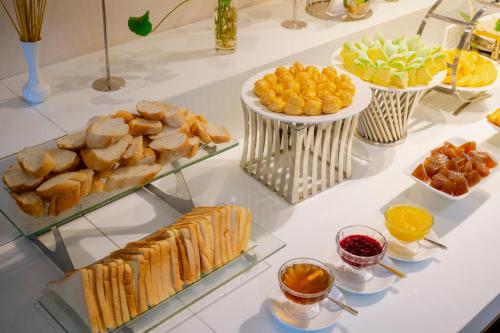 a buffet with different types of food on a table at Astica Hotel Nha trang in Nha Trang