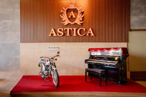 a motorcycle parked in a room with a piano at Astica Hotel Nha trang in Nha Trang