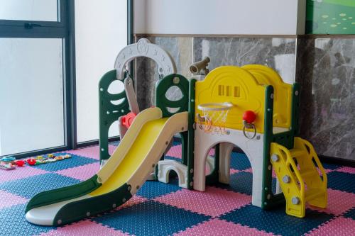a childs play area with a slide and playset at Astica Hotel Nha trang in Nha Trang