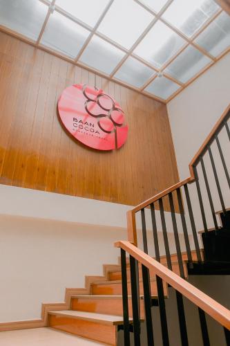 a pink surfboard on the wall of a staircase at Baan Cocoa Boutique Hotel in Natai Beach