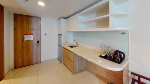 a kitchen with a sink and a counter top at Wing Hotel Kualanamu Airport in Medan