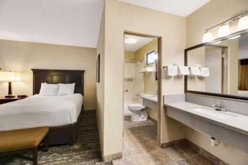 a hotel room with a bed and a bathroom at Best Western Frontier Motel in Lone Pine