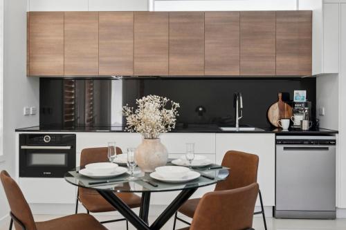 a dining room with a table and chairs in a kitchen at The Break on Diggers - Popular Location, walk to Beach in Coffs Harbour