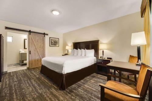a hotel room with a bed and a desk at Best Western Frontier Motel in Lone Pine