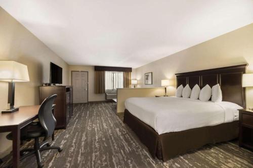 a hotel room with a large bed and a desk at Best Western Frontier Motel in Lone Pine