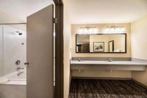 a bathroom with two sinks and a large mirror at Best Western Frontier Motel in Lone Pine