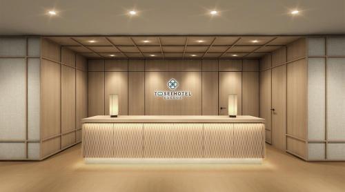 a hotel lobby with a reception counter and a logo at Tosei Hotel Cocone Kamata in Tokyo