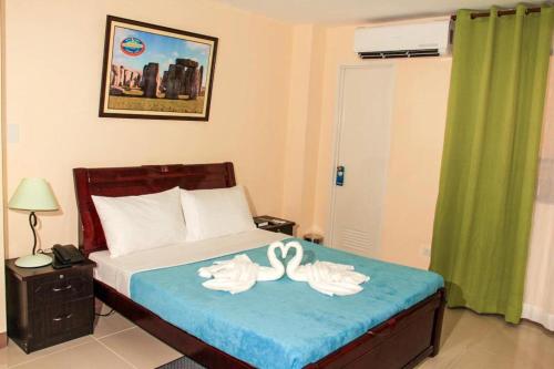 Ένα ή περισσότερα κρεβάτια σε δωμάτιο στο Time Travellers Hotel