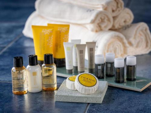 a group of bottles of essential oils on a table at Yufuin Luxury Villa -zakuro- in Yufuin