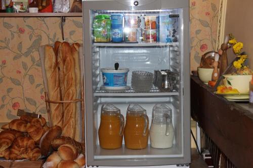 an open refrigerator filled with lots of food and drinks at Hotel Bristol in Châlons-en-Champagne