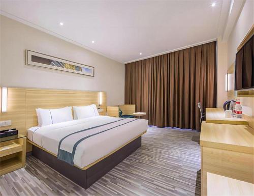 Ένα ή περισσότερα κρεβάτια σε δωμάτιο στο City Comfort Inn Hankou Railway Station Tangjiadun Wanda Plaza