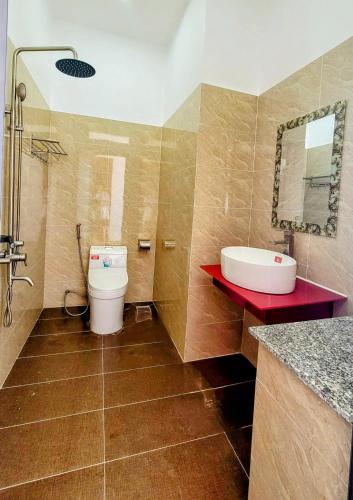 a bathroom with a sink and a toilet at An Thới Ocean View - ẩn mình trên cao tầm nhìn ôm trọn biển in Phú Quốc