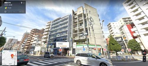 a rendering of a city street with a building at THREE in Tokyo