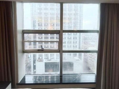 a large window with a view of a city at Xana Hotelle Nanchang Tengwang Pavilion Wanshougong in Nanchang