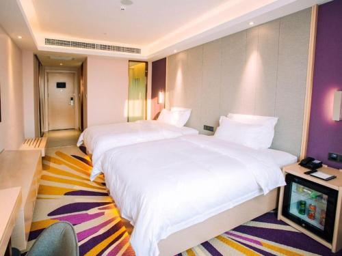 Letto o letti in una camera di Lavande Hotels Jinzhong Youjian Pingyao