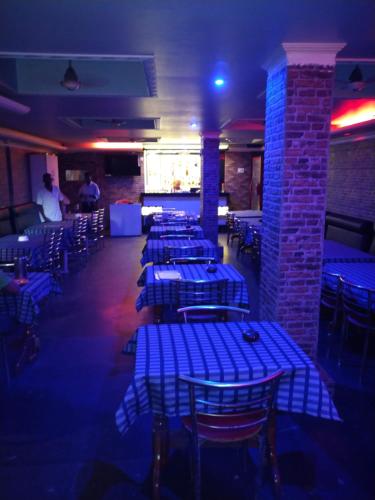 a room with blue tables and chairs in a restaurant at Hotel mansurya in Jamshedpur