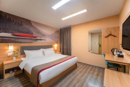 a hotel room with a large bed and a television at Thank Inn Hotel Jiangsu Wuxi High-Tech Zone Ruigang Pedestrian Street in Wuxi
