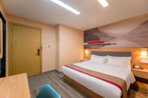 a hotel room with a large bed and a blue chair at Thank Inn Hotel Jiangsu Wuxi High-Tech Zone Ruigang Pedestrian Street in Wuxi