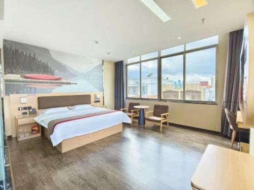 a bedroom with a large bed and a large window at Thank Inn Plus Hotel Guangdong Yunfu Luoding City Municipal in Yunfu