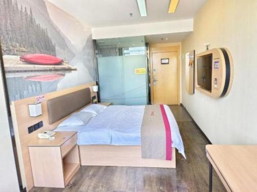 a small bedroom with a bed and a desk at Thank Inn Plus Hotel Guangdong Yunfu Luoding City Municipal in Yunfu