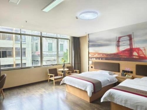 a hotel room with two beds and a large window at Thank Inn Plus Hotel Guangdong Yunfu Luoding City Municipal in Yunfu
